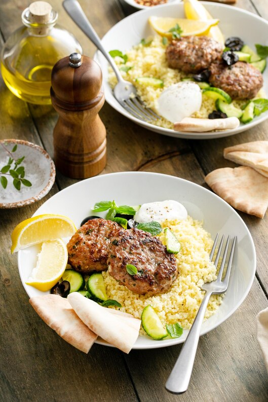 herb-turkey-patties-served-with-couscous-fresh-salad-medium