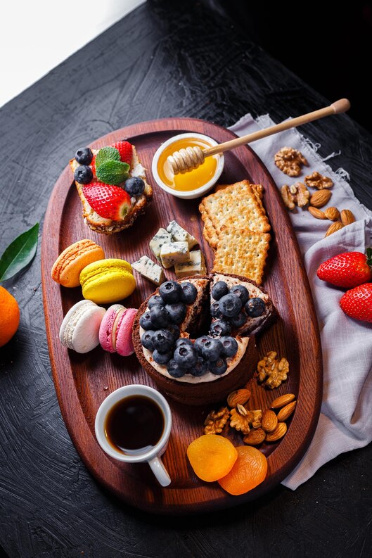 oval-wooden-tray-cake-with-berries-coffee-cup-cheese-crackers-honey-bowl-colored-medium