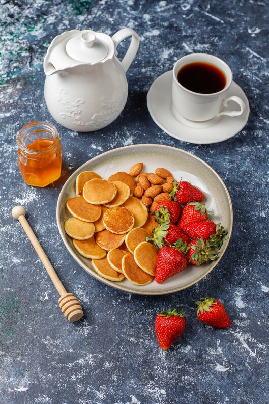 trendy-food-mini-pancake-cereal-heap-cereal-pancakes-with-berries-nuts-medium